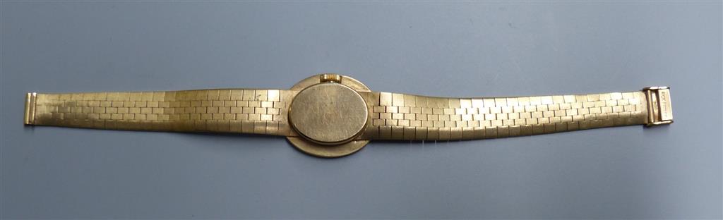A ladys 9ct gold Bueche Girod manual wind wrist watch, on a textured 9ct gold bracelet, 15.7cm, gross 23.5 grams.